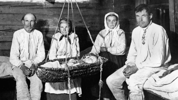 The Winnik family by the cradle; Kosów Poleski district, Polesye Voivodeship, Poland. Photograph by Józef Szymanczyk, 1937. Courtesy of Irena Domanska